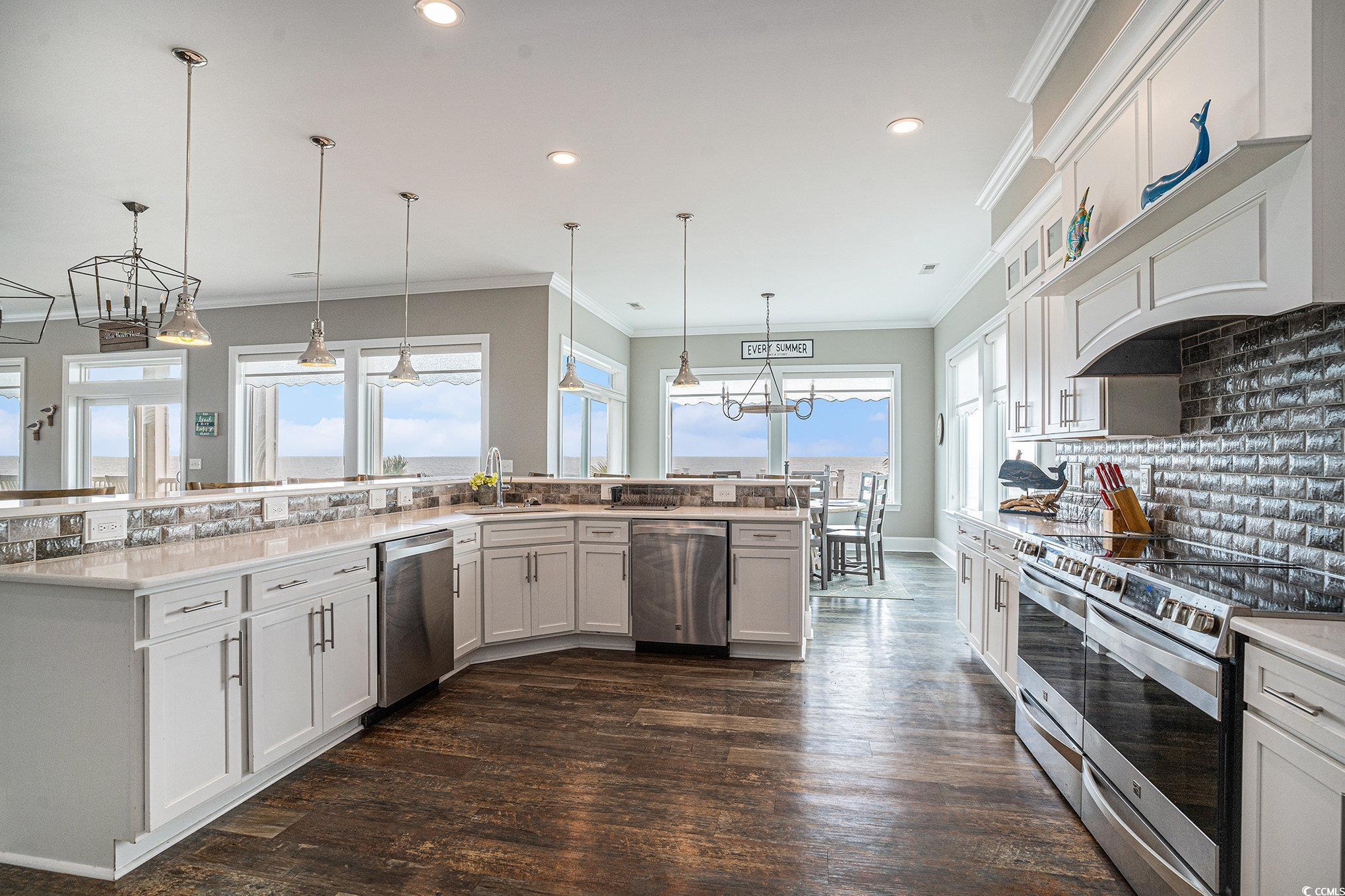1907 South Waccamaw Drive Murrells Inlet, SC 29576 - Photo 12 of 40 Kitchen with tasteful backsplash, dark hardwood / wood-style flooring, appliances with stainless steel finishes, and plenty of natural light