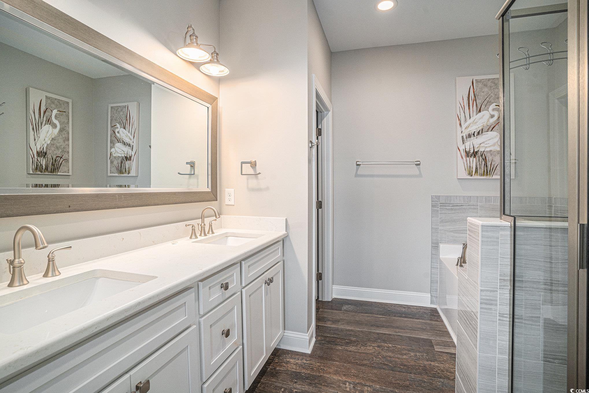 1907 South Waccamaw Drive Murrells Inlet, SC 29576 - Photo 16 of 40 Bathroom featuring shower with separate bathtub, wood-type flooring, and double sink vanity