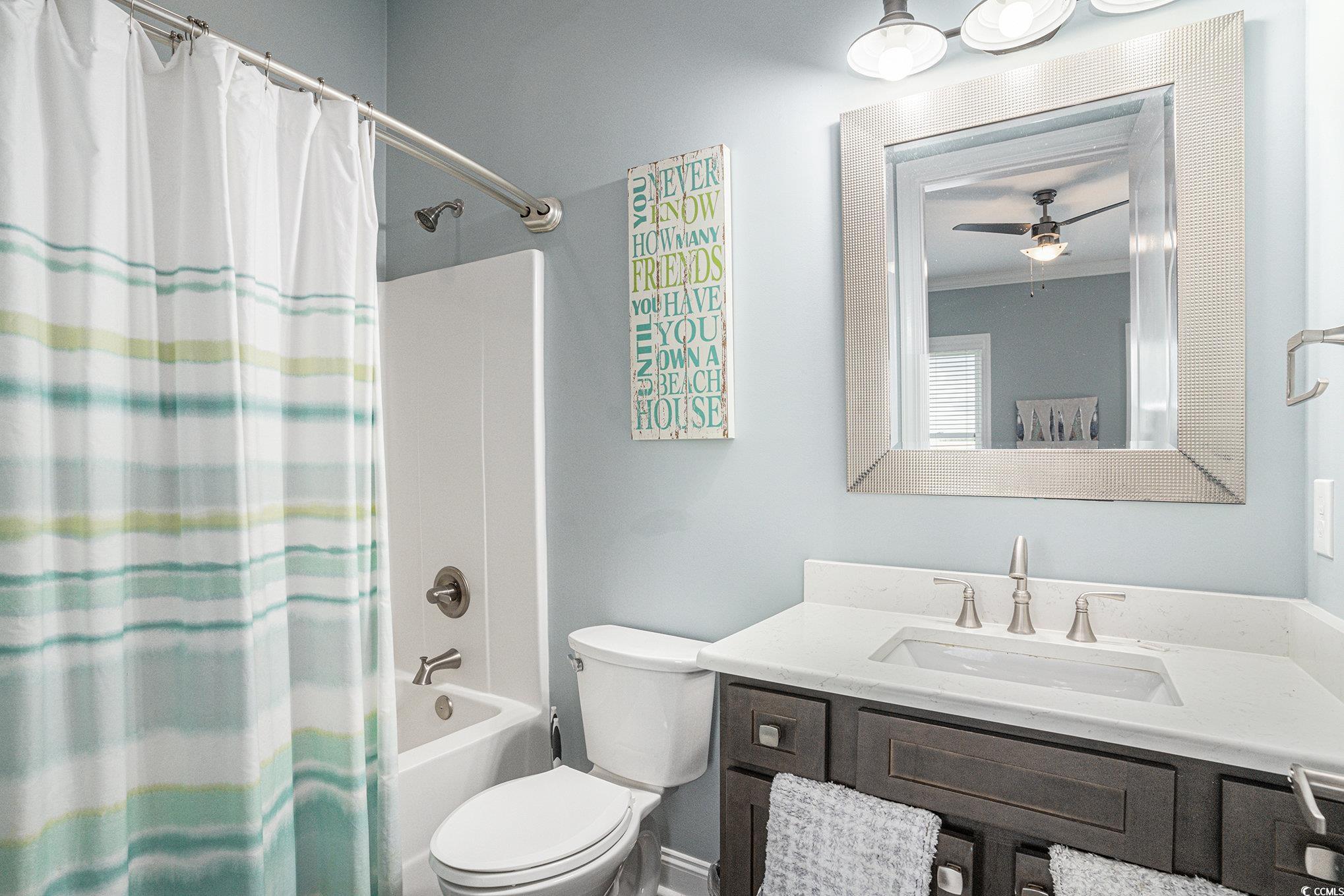 1907 South Waccamaw Drive Murrells Inlet, SC 29576 - Photo 21 of 40 Full bathroom featuring vanity, ceiling fan, crown molding, shower / bath combination with curtain, and toilet