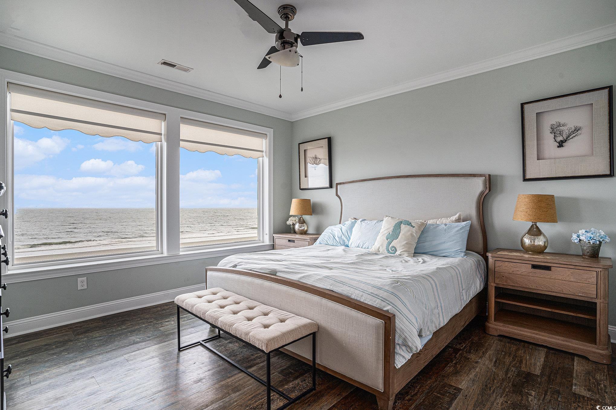 1907 South Waccamaw Drive Murrells Inlet, SC 29576 - Photo 25 of 40 Bedroom featuring crown molding, dark wood-type flooring, ceiling fan, and a water view