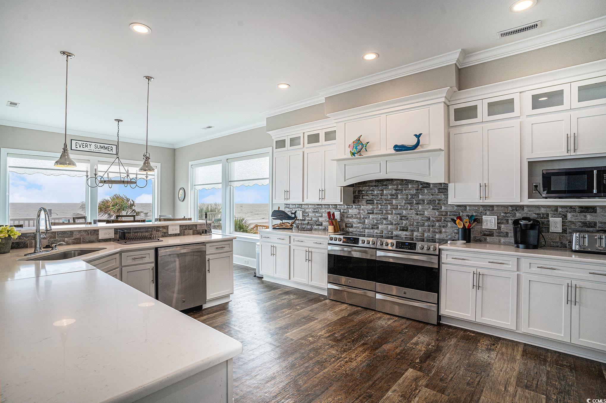 1907 South Waccamaw Drive Murrells Inlet, SC 29576 - Photo 5 of 40 Kitchen featuring tasteful backsplash, white cabinets, dark hardwood / wood-style flooring, double ovens, appliances with stainless steel finishes
