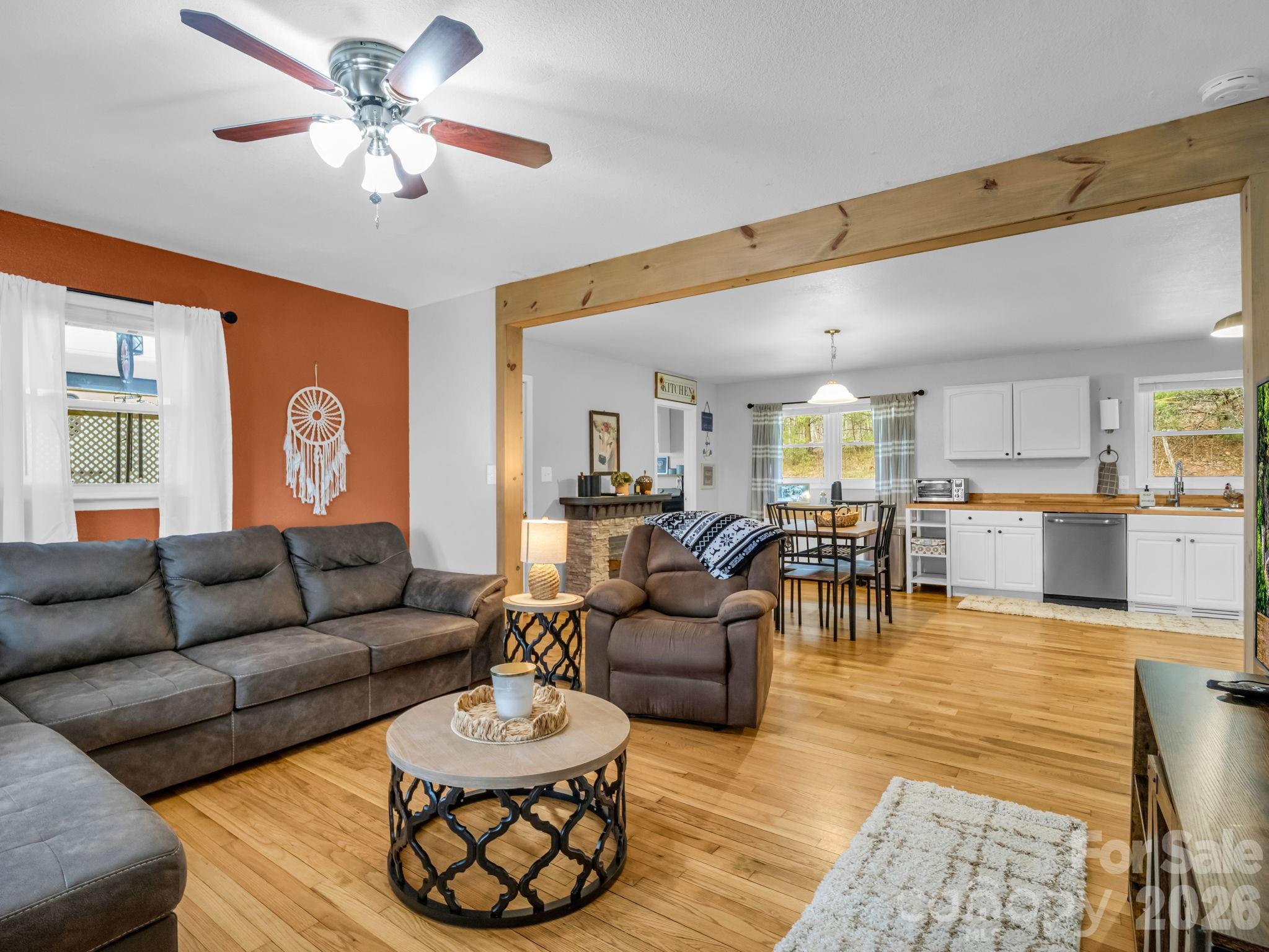 248 Bible School Road Lake Lure, NC 28746 - Photo 12 of 38 a living room with furniture kitchen view and a chandelier