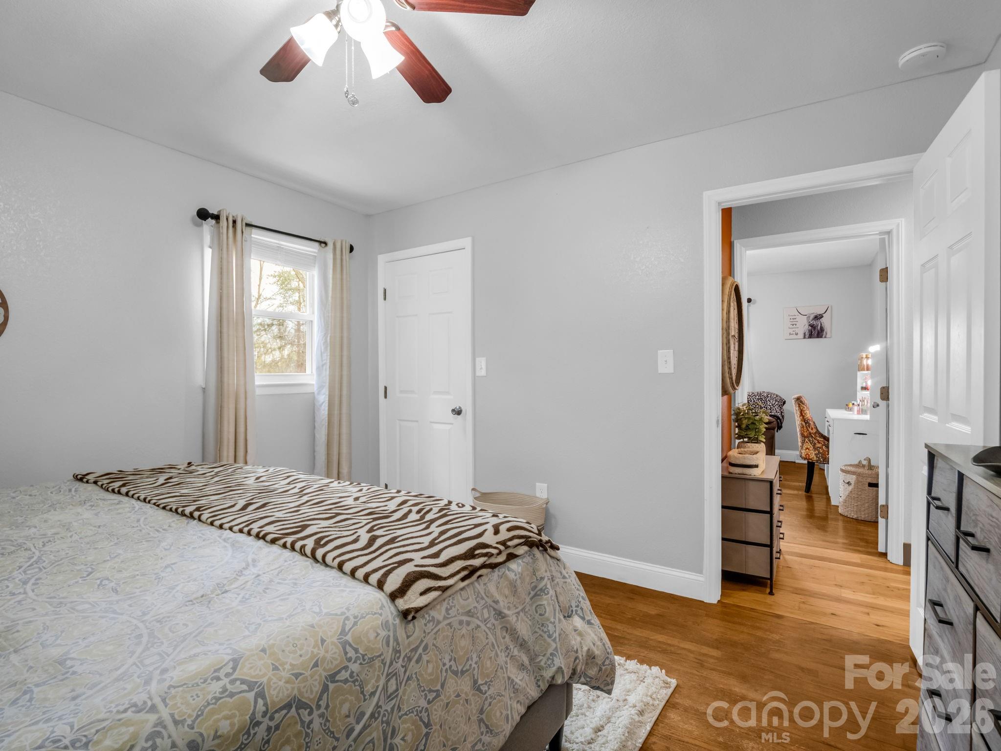248 Bible School Road Lake Lure, NC 28746 - Photo 30 of 38 a bedroom with a bed and a chandelier