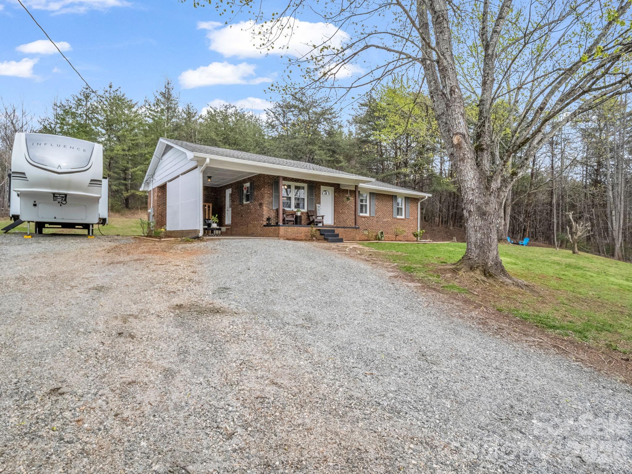 248 Bible School Road Lake Lure, NC 28746 - Photo 5 of 38 a view of a house with a yard and large tree