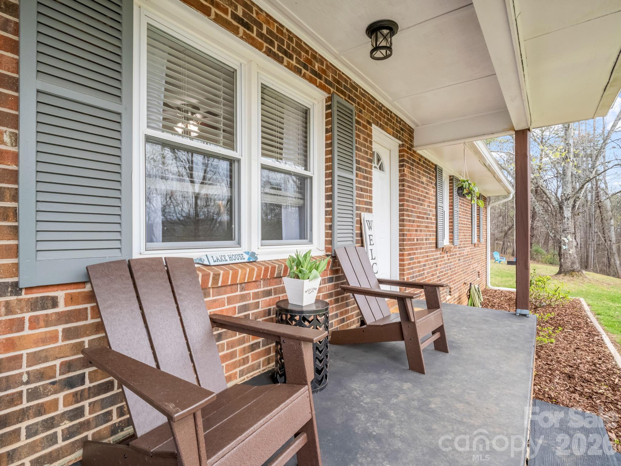 248 Bible School Road Lake Lure, NC 28746 - Photo 8 of 38 a view of a patio with a table and chairs
