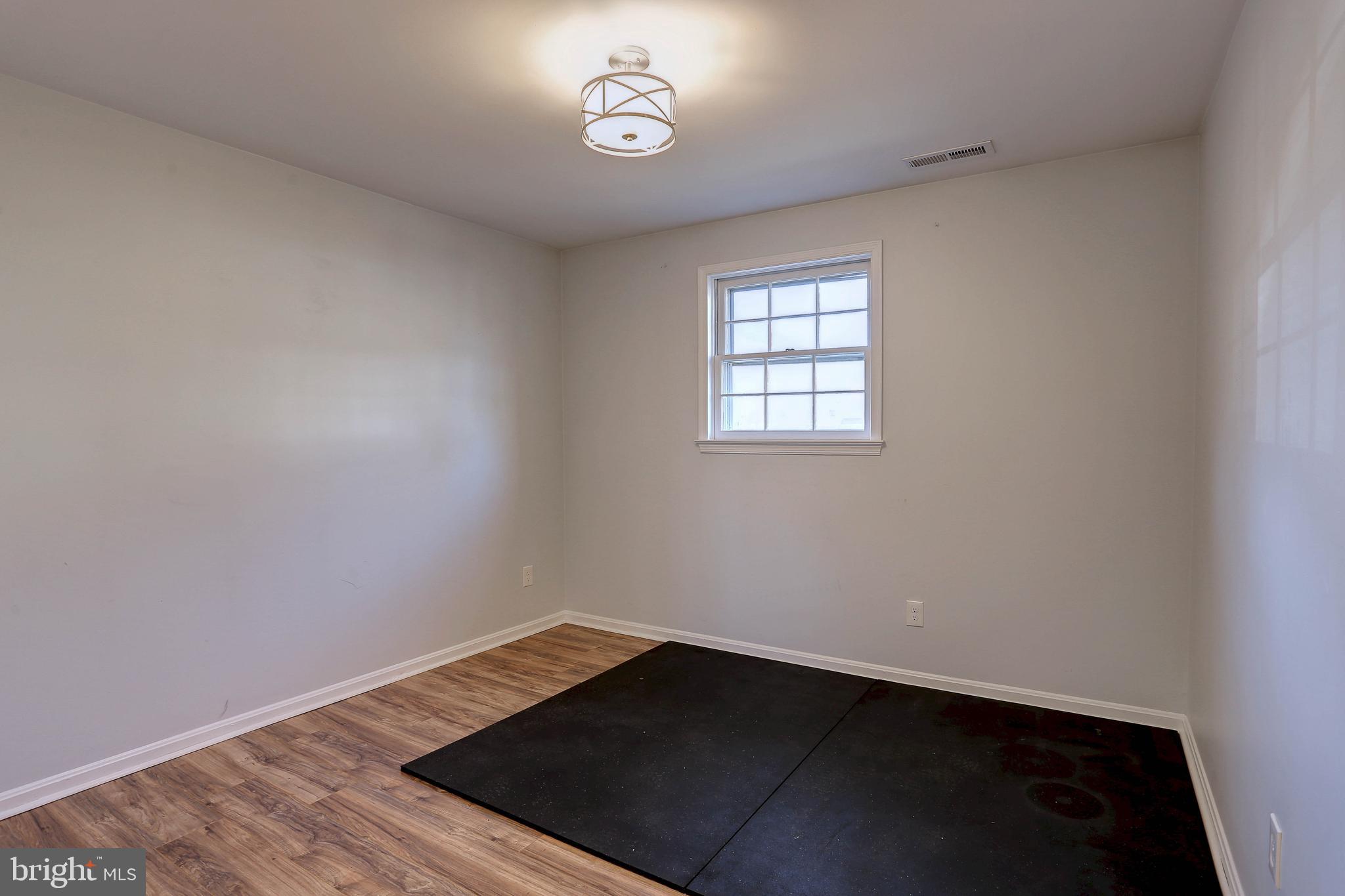 800 A Barrett Avenue Arnold, MD 21012 - Photo 13 of 30 an empty room with wooden floor and windows