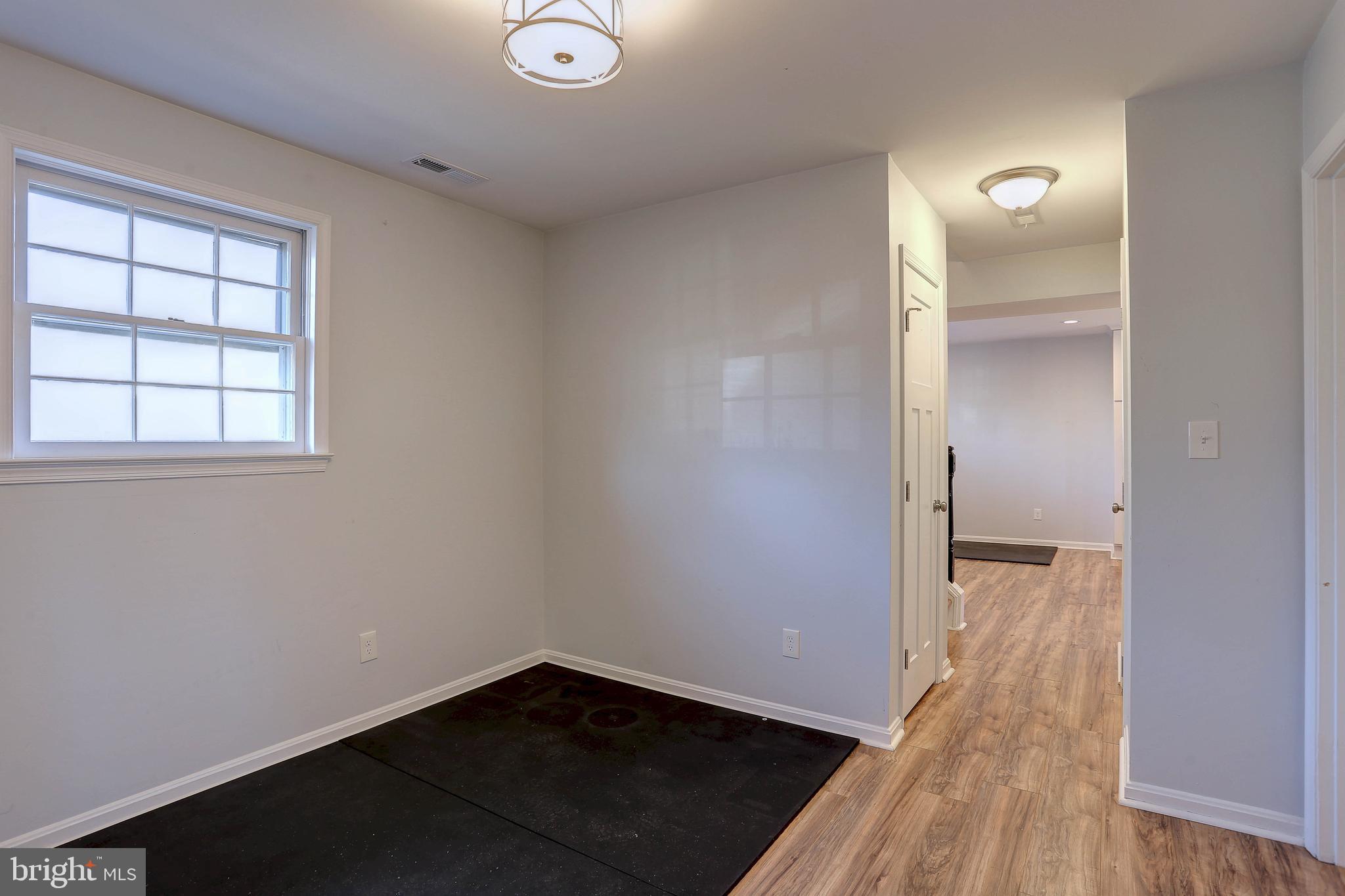 800 A Barrett Avenue Arnold, MD 21012 - Photo 14 of 30 an empty room with wooden floor and windows