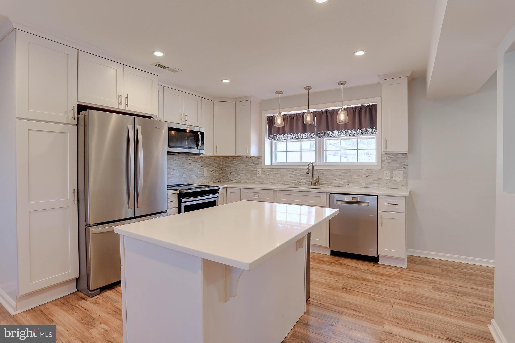 800 A Barrett Avenue Arnold, MD 21012 - Photo 7 of 30 a kitchen with granite countertop a refrigerator and a stove top oven