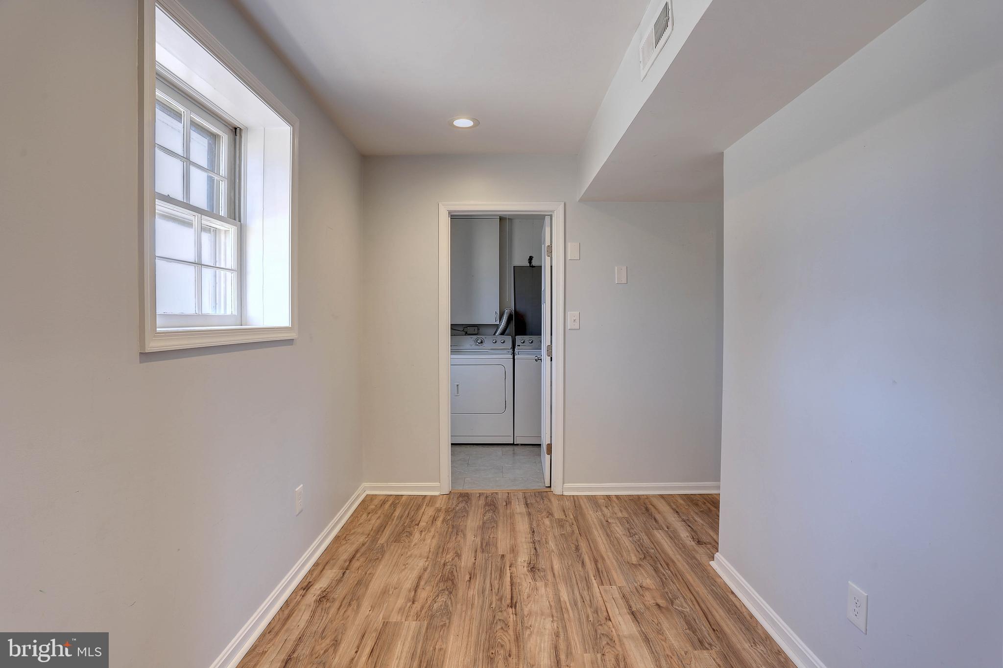 800 A Barrett Avenue Arnold, MD 21012 - Photo 8 of 30 an empty room with wooden floor and windows