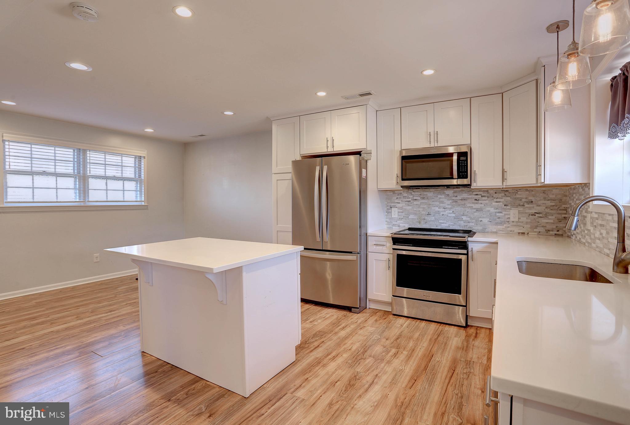 800 A Barrett Avenue Arnold, MD 21012 - Photo 10 of 30 a kitchen with kitchen island a sink stainless steel appliances and cabinets