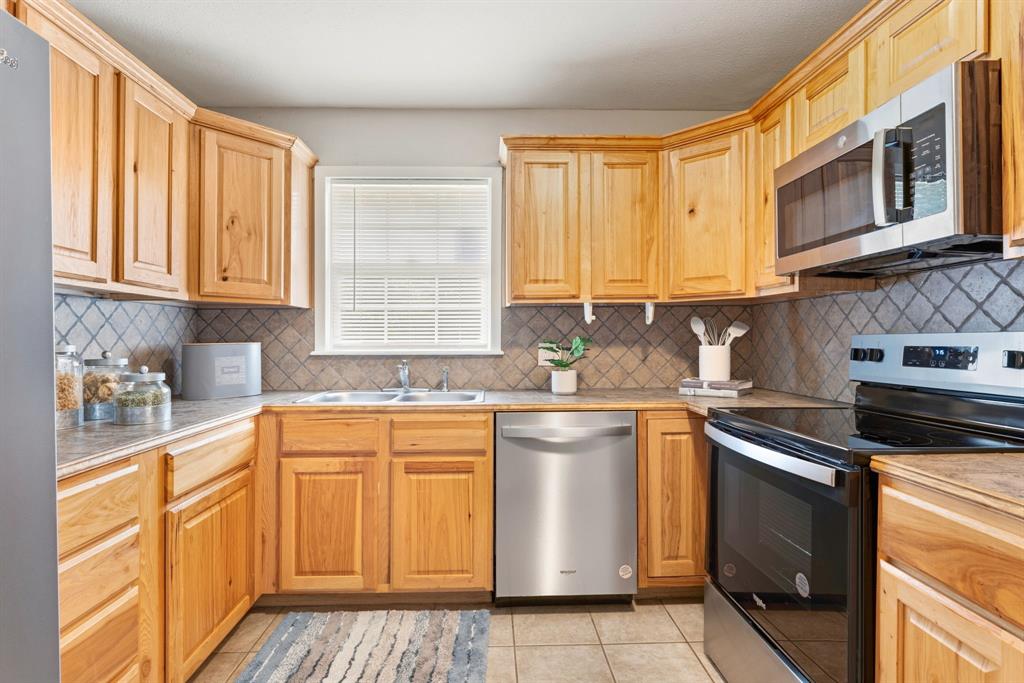 1236 South Brazos Street Weatherford, TX 76086 - Photo 12 of 25 Kitchen with updated appliances and built-in pantry