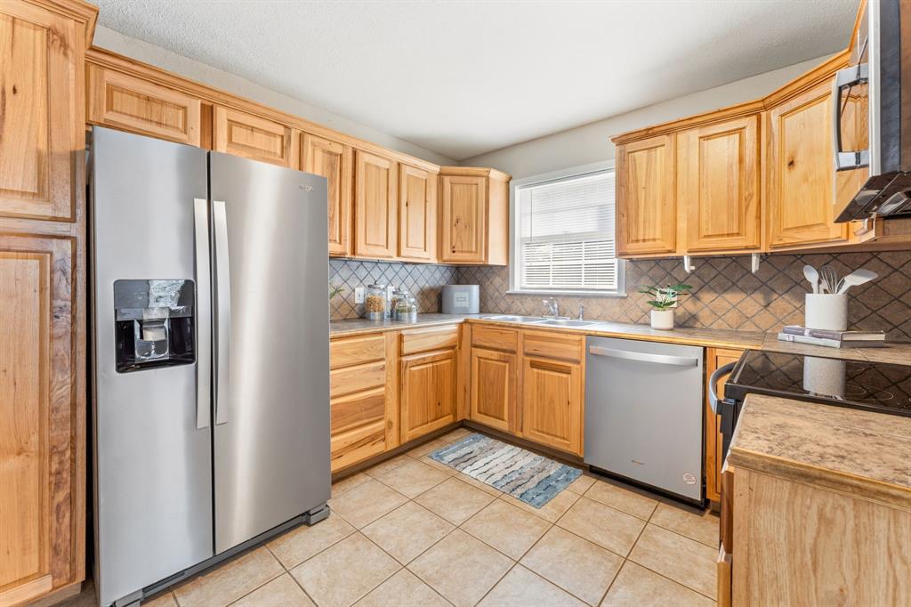 1236 South Brazos Street Weatherford, TX 76086 - Photo 13 of 25 Kitchen with updated appliances and built-in pantry
