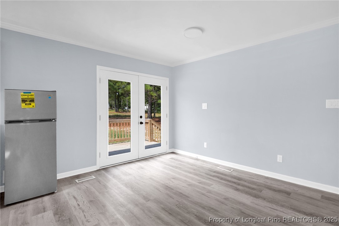 258 Brower Road Cameron, NC 28326 - Photo 12 of 24 a view of an empty room with wooden floor and a window