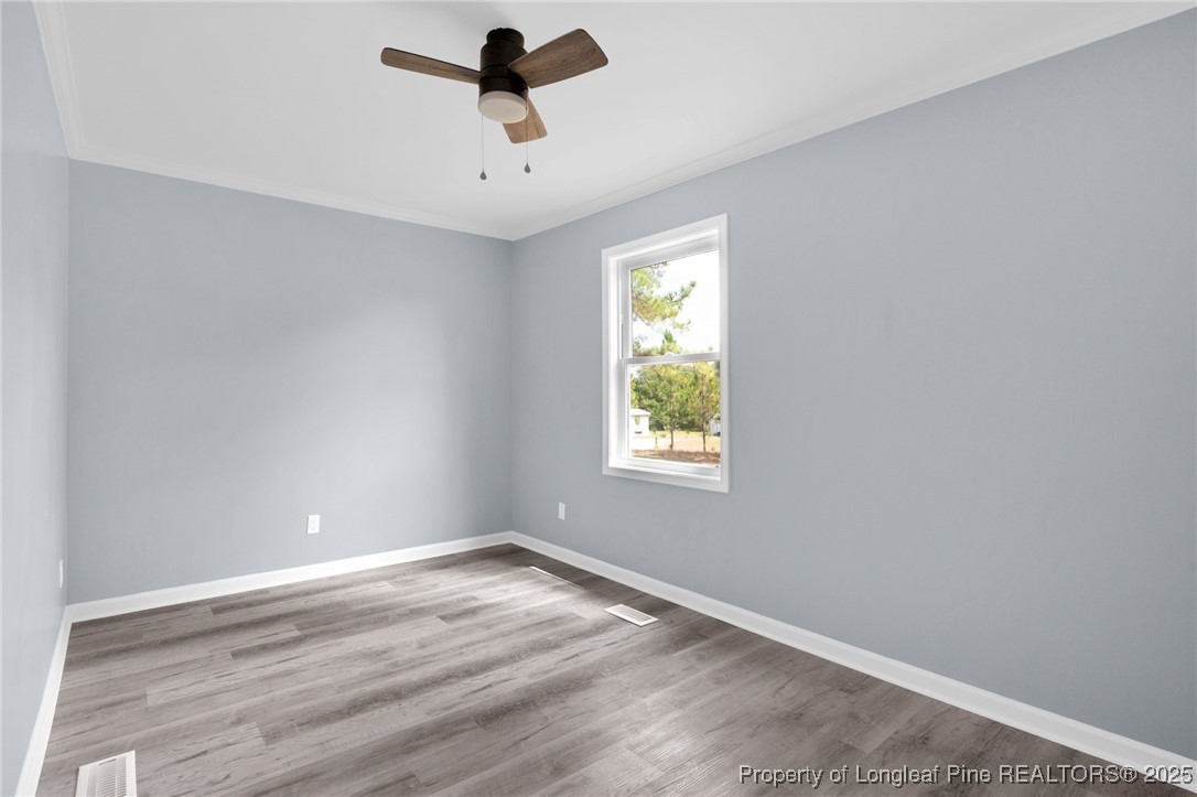 258 Brower Road Cameron, NC 28326 - Photo 17 of 24 an empty room with a window and a ceiling fan