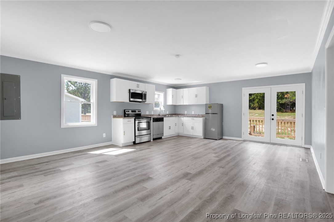 258 Brower Road Cameron, NC 28326 - Photo 8 of 24 a view of a kitchen with wooden floor electronic appliances and window