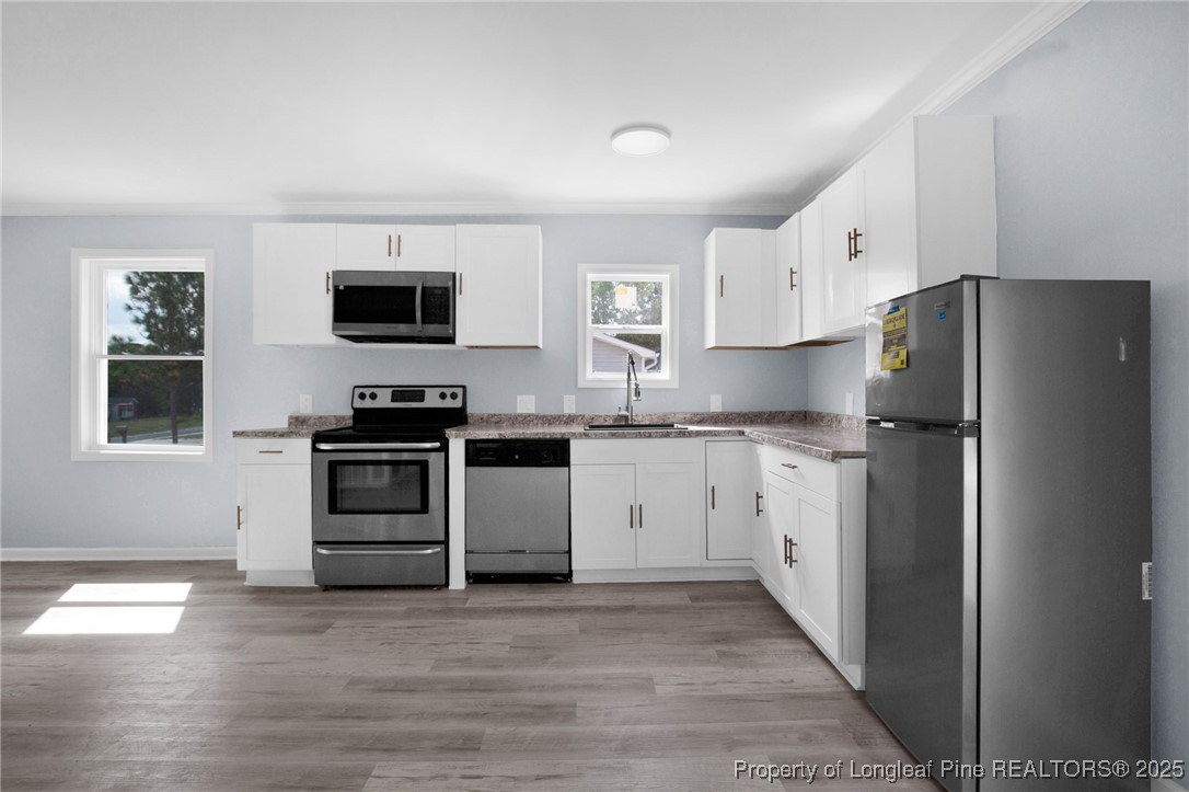 258 Brower Road Cameron, NC 28326 - Photo 10 of 24 a kitchen with stainless steel appliances a refrigerator stove and microwave