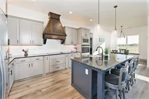 a kitchen with a sink stainless steel appliances and cabinets