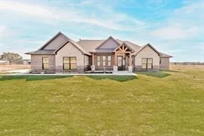 a front view of a house with a yard table and chairs
