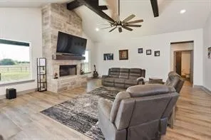 a living room with furniture a flat screen tv and a fireplace