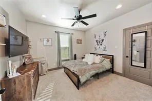 a spacious bedroom with a bed and a flat screen tv