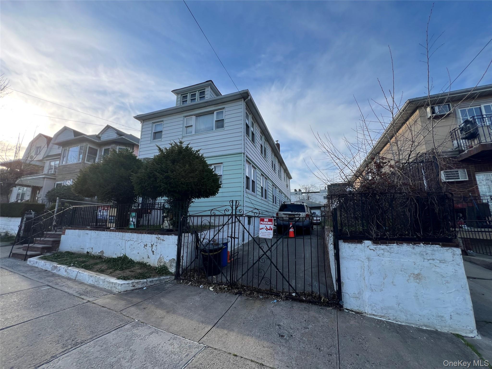 111-09 34th Avenue Queens, NY 11368 - Photo 1 of 4 a view of a house with a wooden fence