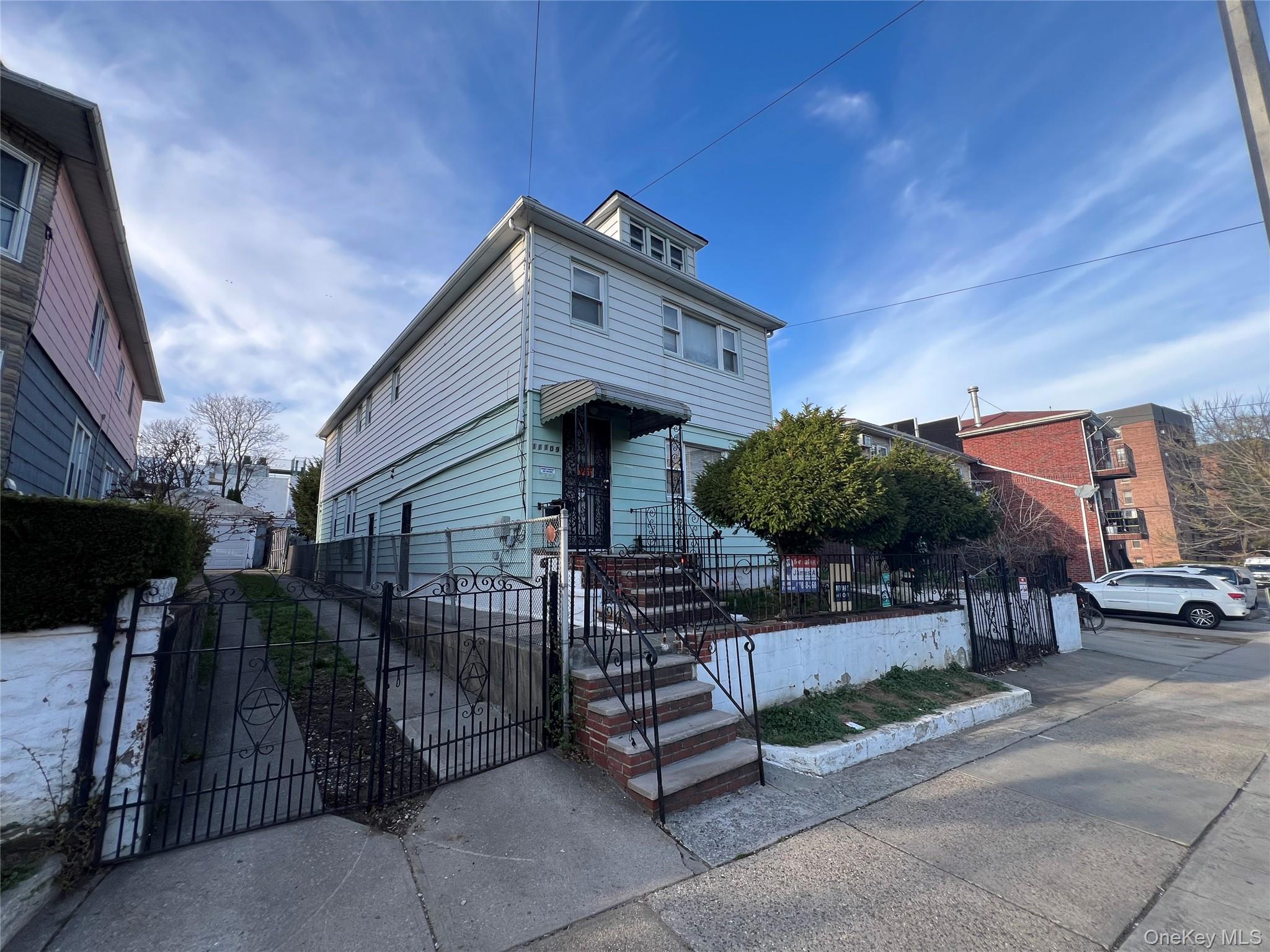111-09 34th Avenue Queens, NY 11368 - Photo 2 of 4 a front view of a house with garden