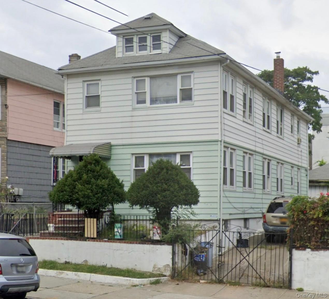 111-09 34th Avenue Queens, NY 11368 - Photo 3 of 4 a front view of a house with a yard
