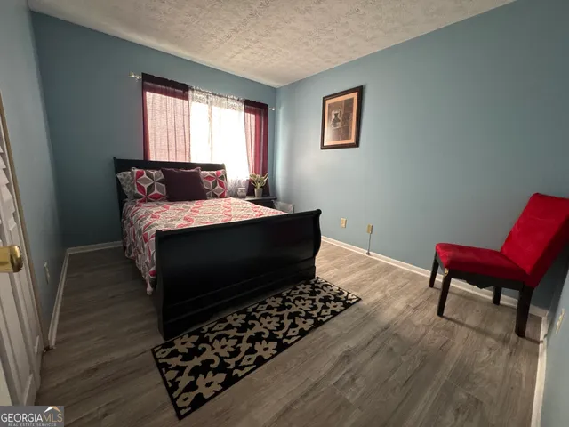 a living room with a couch wooden floor and a window