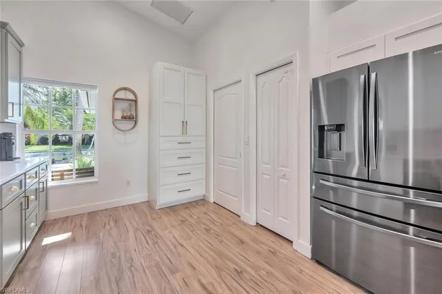 a kitchen with stainless steel appliances a refrigerator stove and wooden floor