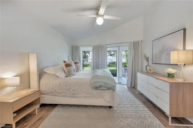 a spacious bedroom with a bed and a lamp