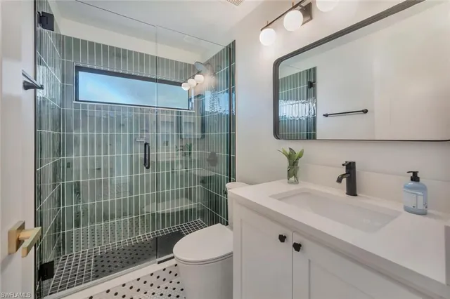 a bathroom with a sink toilet and shower
