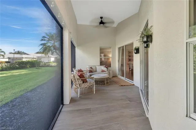 a living room with patio furniture and garden