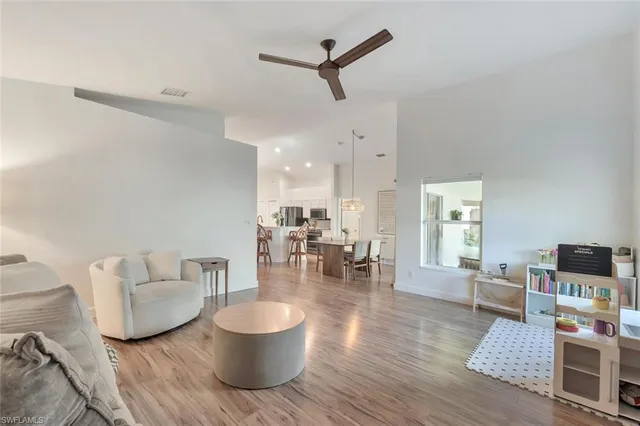 a living room with furniture and a wooden floor