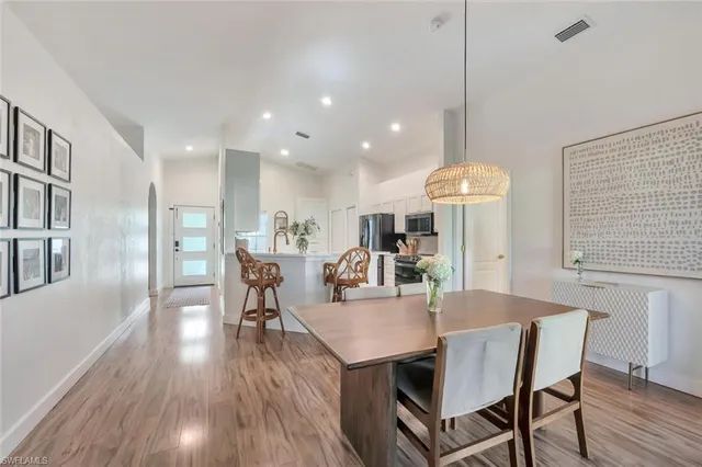 a dining room with furniture and wooden floor