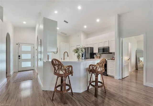 a view of a dining room with furniture and wooden floor