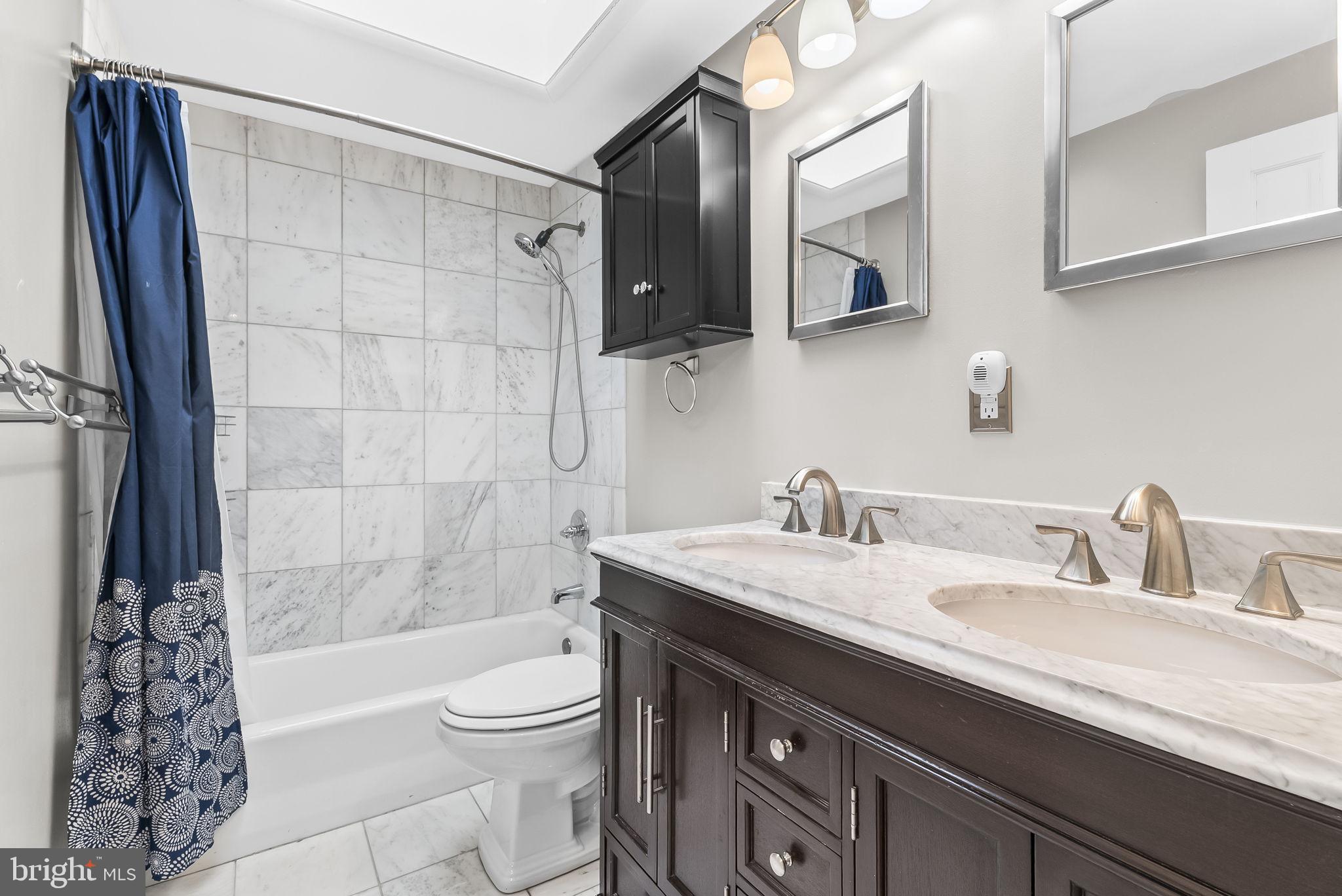 433 Earl Street Alexandria, VA 22314 - Photo 21 of 30 a bathroom with a granite countertop sink toilet and shower