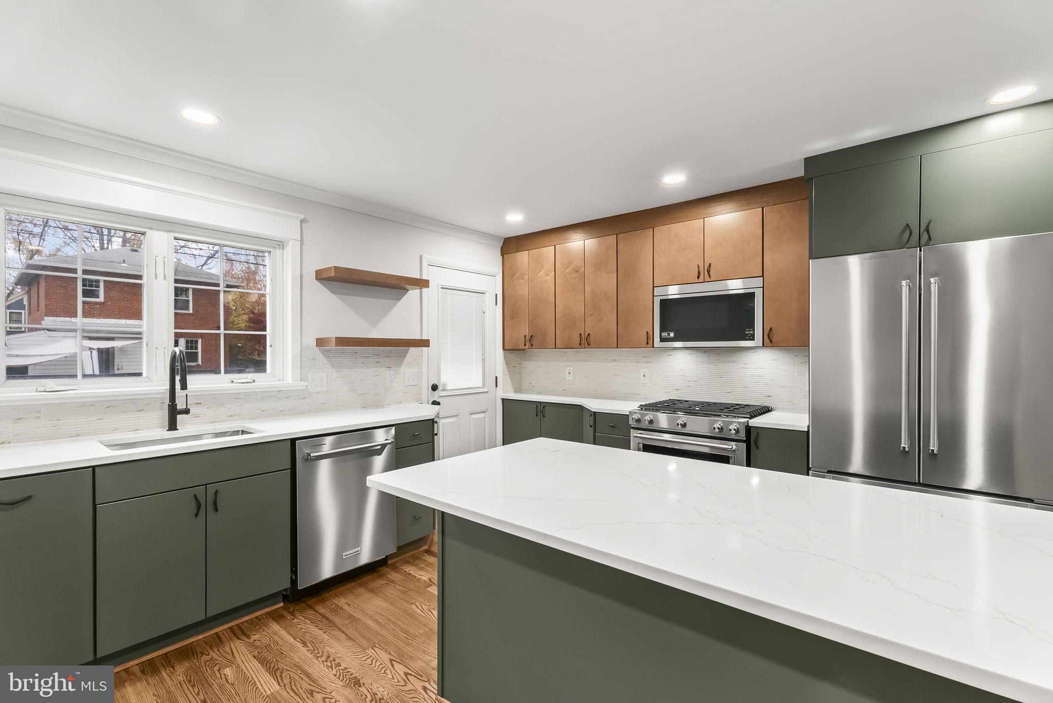433 Earl Street Alexandria, VA 22314 - Photo 10 of 30 a kitchen with a sink a stove and refrigerator