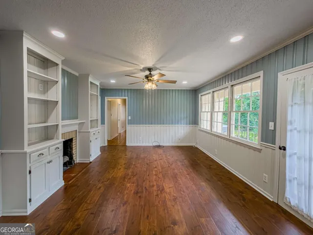 a view of a room with window wooden floor and a ceiling fan