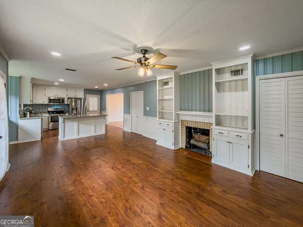 a view of a livingroom with a furniture wooden floor a chandelier