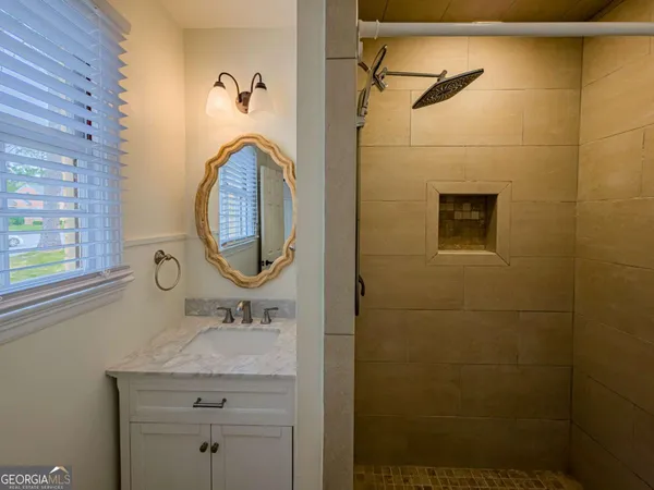 a bathroom with a sink a toilet and mirror