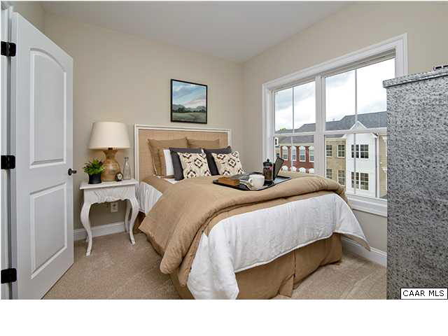 2068 Avinity Loop Charlottesville, VA 22902 - Photo 14 of 16 a bedroom with a bed and a lamp