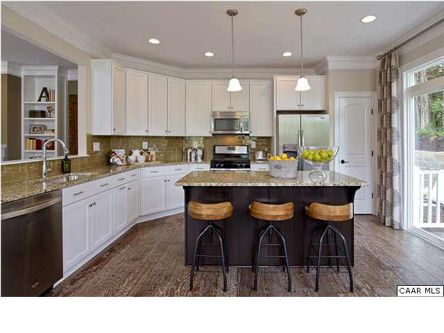 2068 Avinity Loop Charlottesville, VA 22902 - Photo 5 of 16 a kitchen with granite countertop a table chairs sink and cabinets