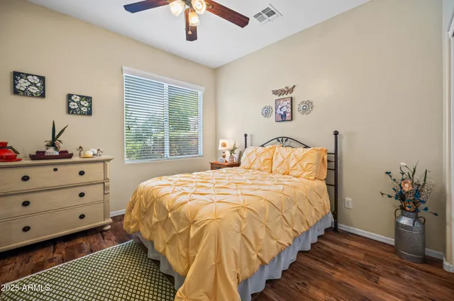 a bedroom with a bed and a potted plant