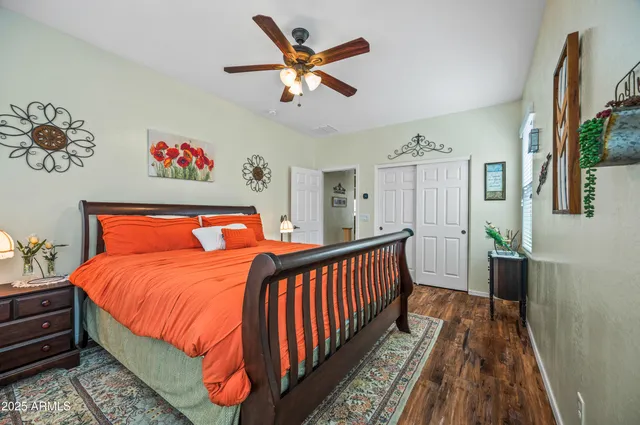 a bedroom with a bed and a large window