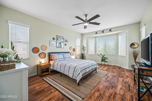 a bedroom with a bed table and a window