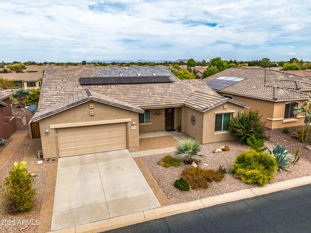 an aerial view of a house with a yard