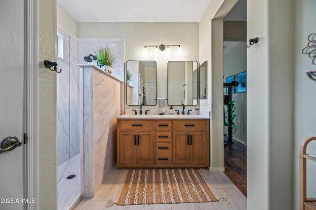 a bathroom with a sink a mirror and a shower