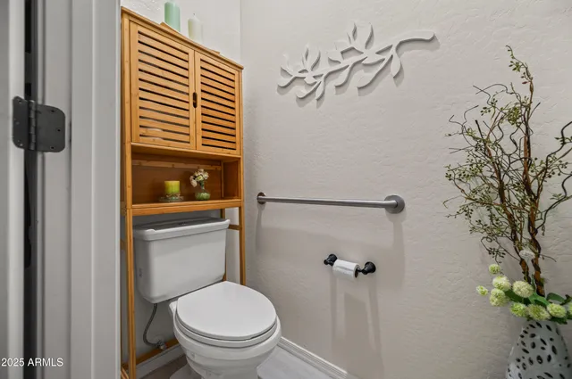 a white toilet sitting next to a shower