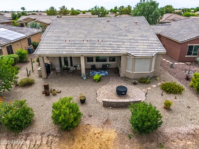 an aerial view of a house with a yard and potted plants