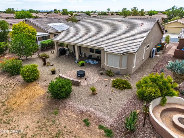 an aerial view of a house with garden space and sitting area